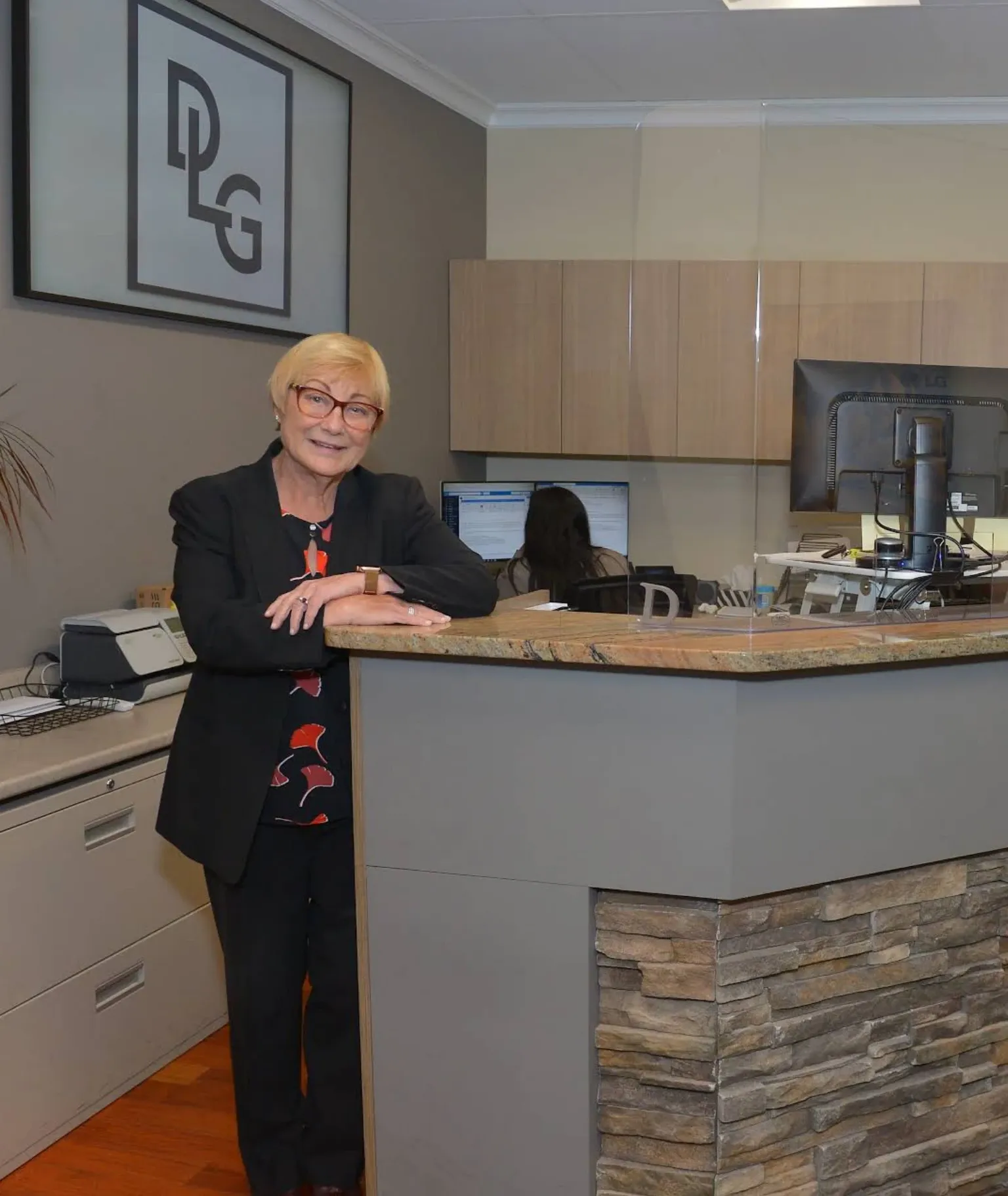 Rebecca Darnell at the front desk of the Darnell Law Group office in Surrey